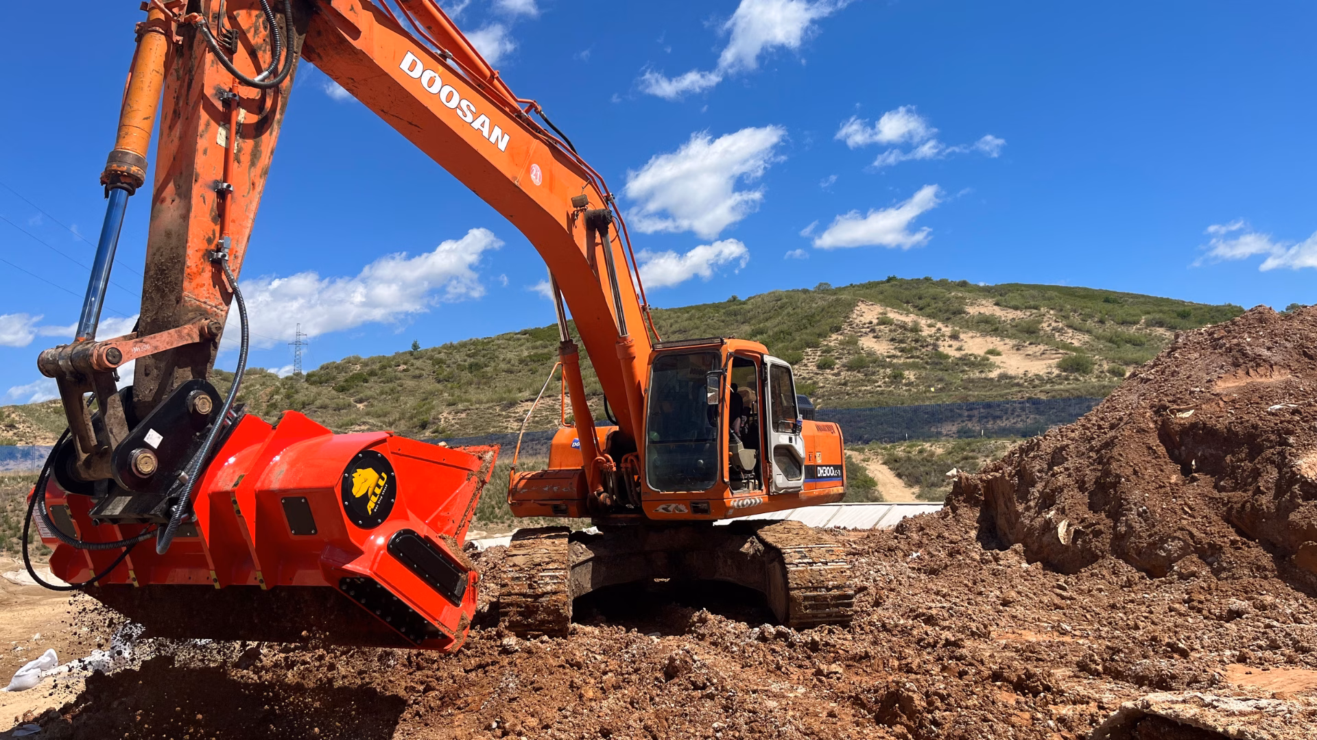 ALLU screening bucket mixing and screening arsenic-contaminated soil during on-site remediation.
